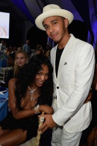 Naomi Campbell shows her cleavage and Lewis Hamilton leaning on the chair at Leonardo DiCaprio Foundation Gala in St. Tropez