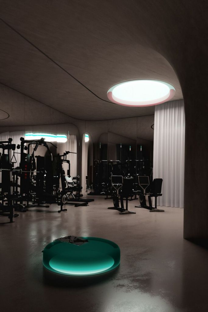 A modern gym area in an underground house featuring fitness equipment, softly illuminated space, and a unique round light fixture on the ceiling.