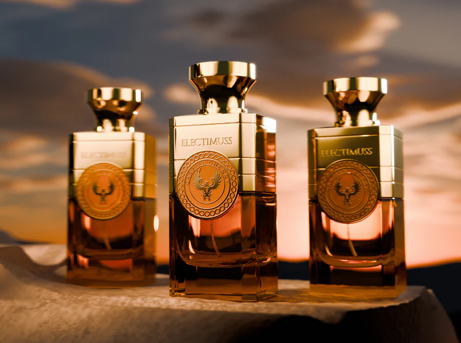 Three elegant perfume bottles with gold caps and logos, labeled "ELECTIMUSS," set against a serene sunset sky backdrop, exuding luxury and sophistication.