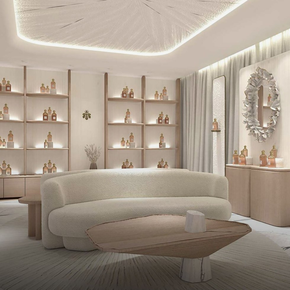 Elegant room with white furniture and shelves, showcasing the luxurious ambiance of the Guerlain spa Monaco perfume area.