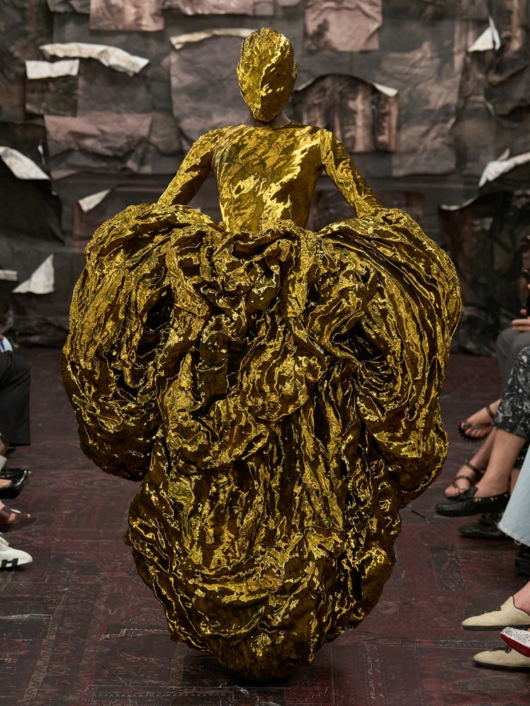 fashion model walking the runway in oversized haute couture velvet gown