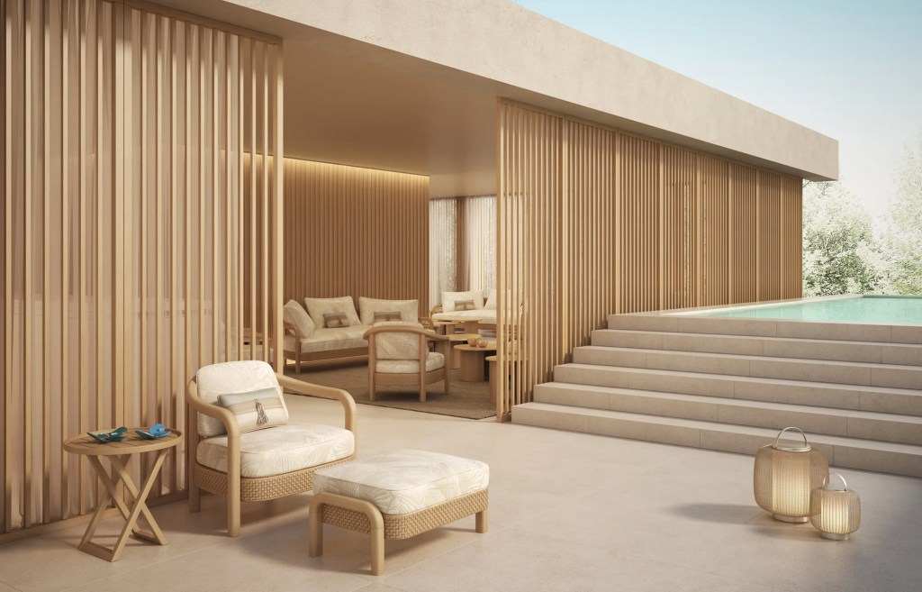 Sand coloured outdoor terrace with summer wooden furniture featuring the stairs to the swimming pool.