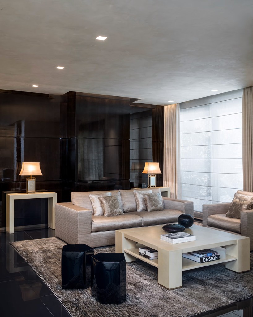 Common area for relaxation, elegant and cozy, features designer furniture in neutral tones.