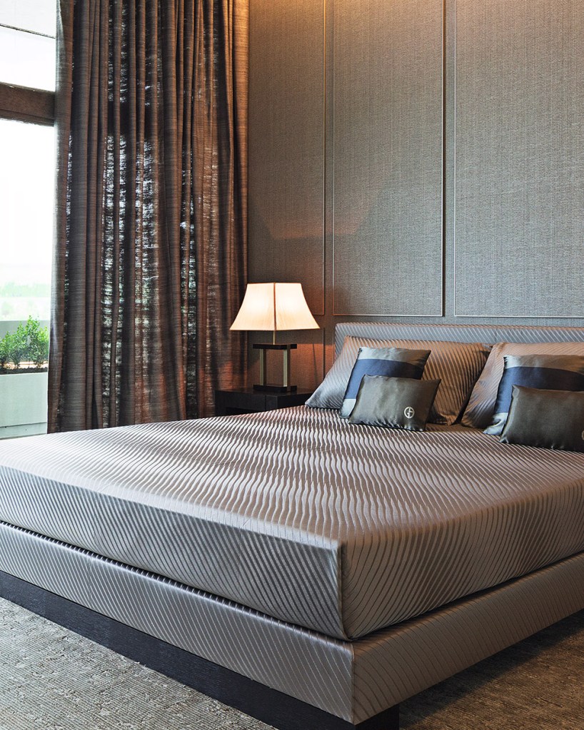 Bedroom interior design in grey and charcoal colors by Italian designer Giorgio Armani.