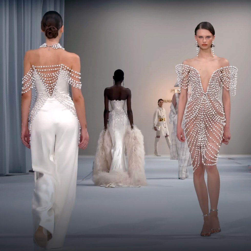Catwalk models walking the runway in white outfits with pearl accessories in Paris.