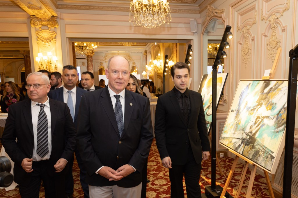 Guests in the ornate Salle Belle Époque at the Hôtel Hermitage Monte-Carlo attending the launch event of Jardins d’Arménie Royal Brandy, including prominent figures and artworks displayed.