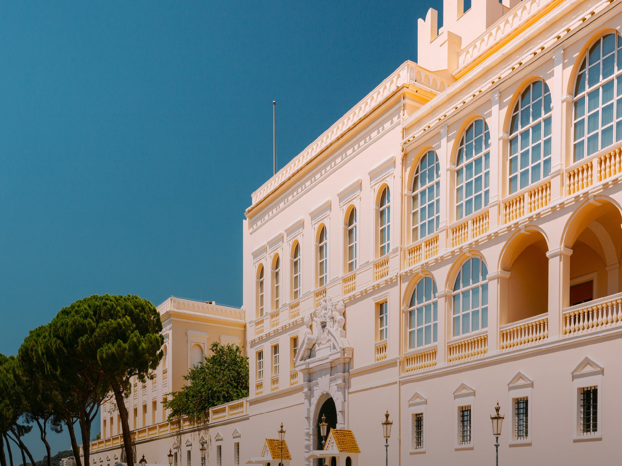monaco royal palace exterior on a sunny day with blue sky
