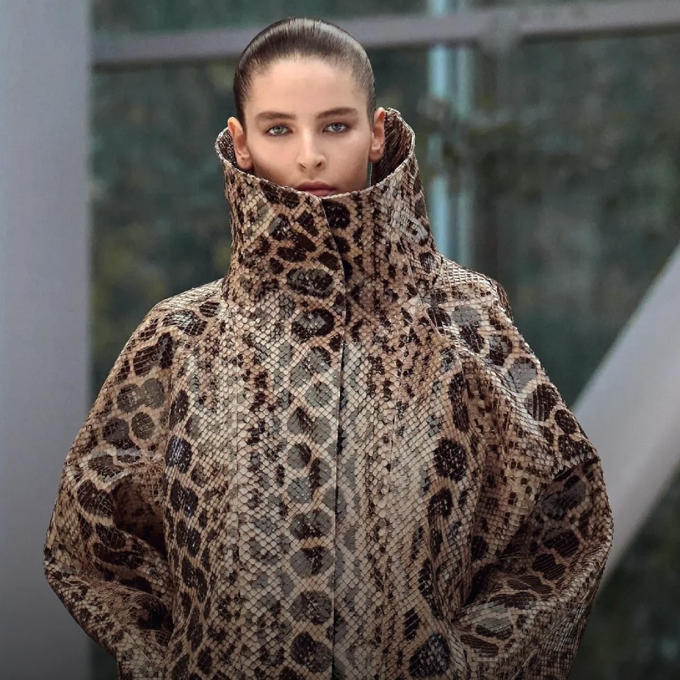 Alaïa model in stylish snake-patterned coat.