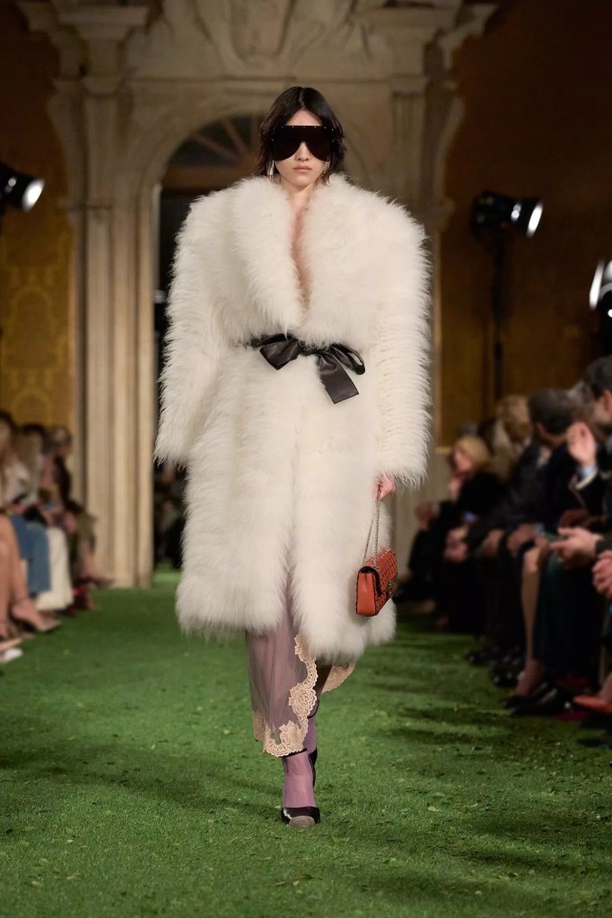 Valentino Fashion Show Fall 2026 model wears white fake fur coat and oversized sunglasses