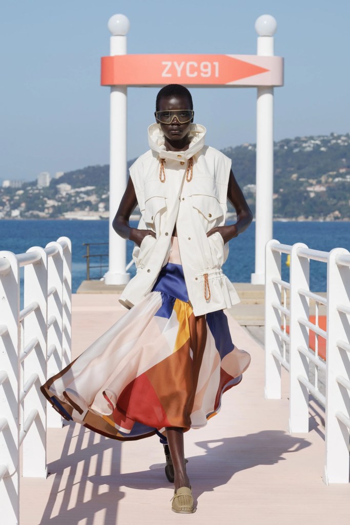 mixed-race runaway model at Zimmermann fashion show in white sleeveless vest and colourful satin skirt
