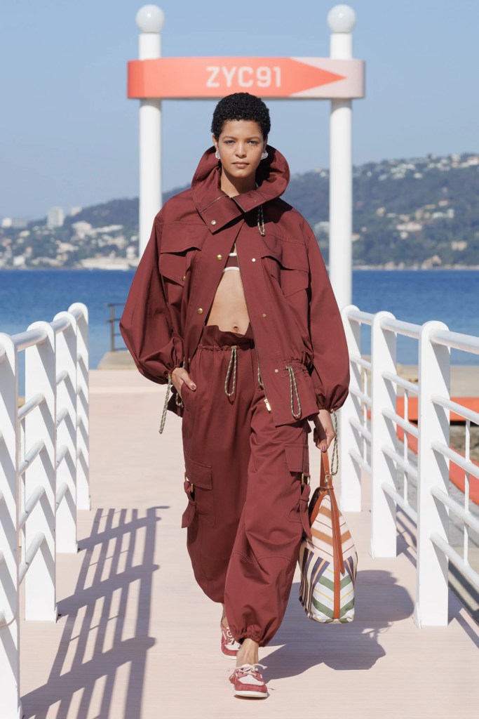 mixed-race runaway model at Zimmermann fashion show in red jacket and pants