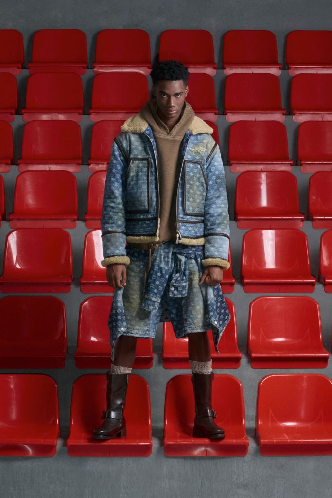 dsquared black male models in brown hoodie and denim shorts and jacket, standing on red stadium plastic chairs