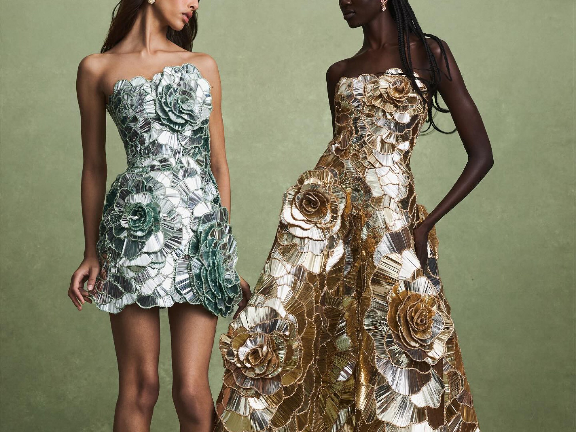Oscar de la Renta silver and gold flower dresses presented by fashion models on the soft green background