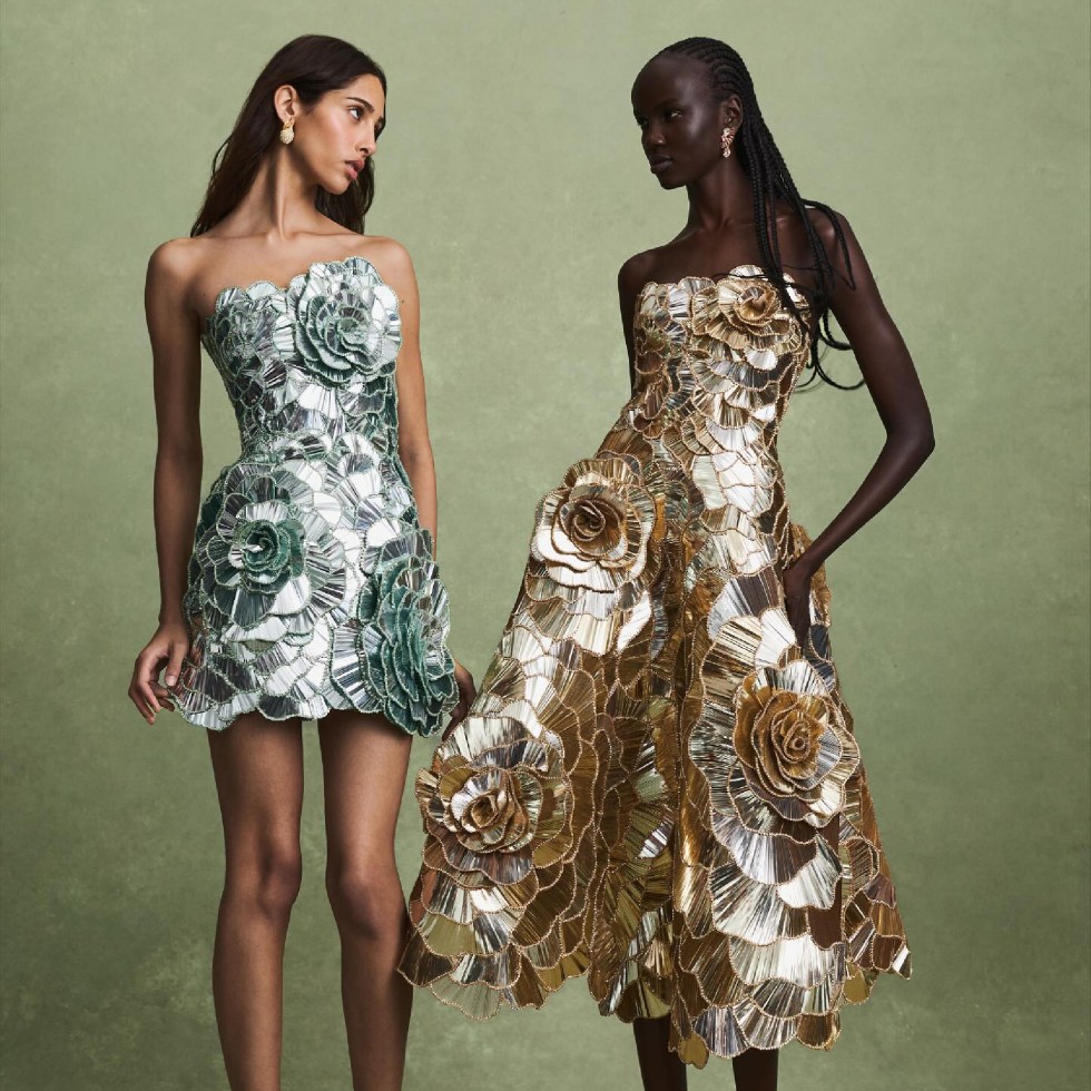 Oscar de la Renta silver and gold flower dresses presented by fashion models on the soft green background