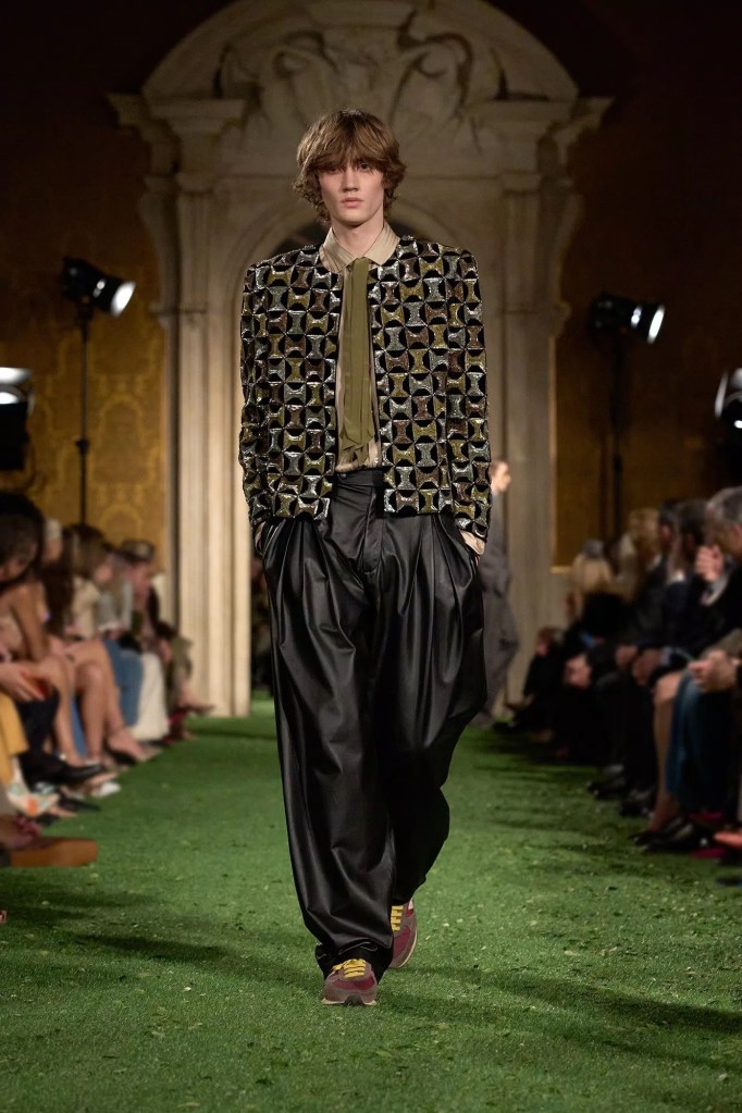 Valentino Fashion Show Fall 2026 model wears black pants and olive top