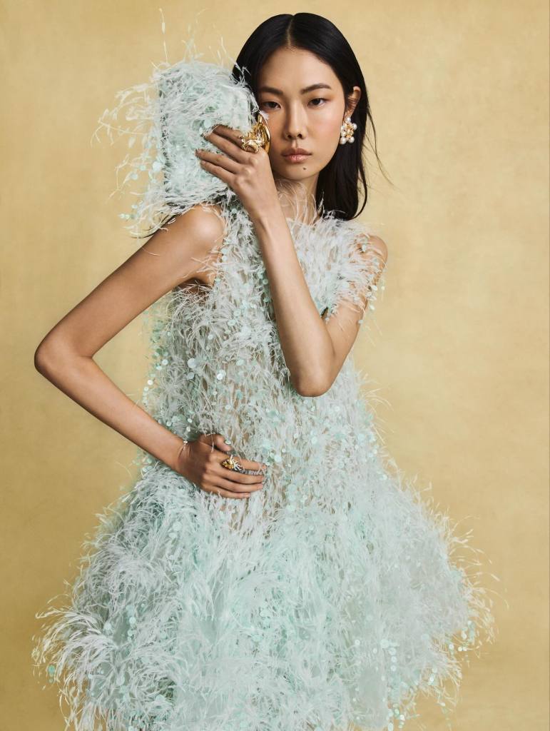 Oscar de la Renta fluffy baby blue feather dress and clutch presented by an Asian beautiful woman