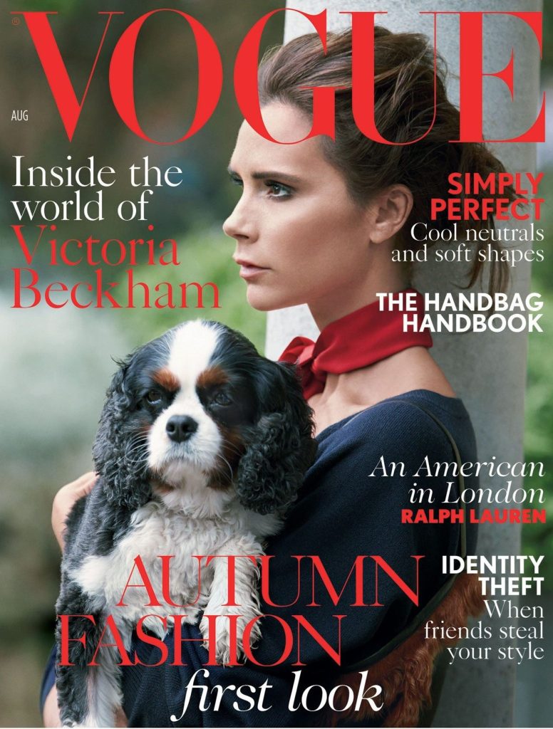 victoria beckham holding a poodle dog in the forest