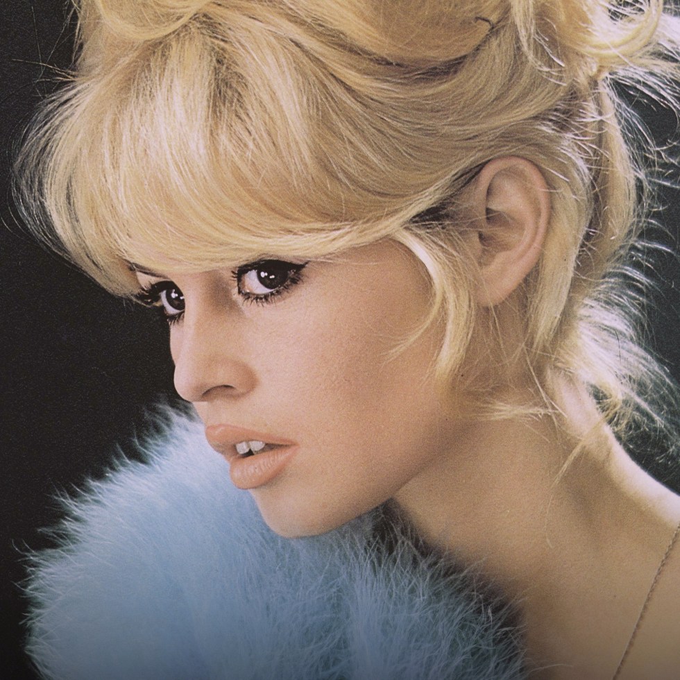 Brigitte Bardot profile portrait wearing blue feathers