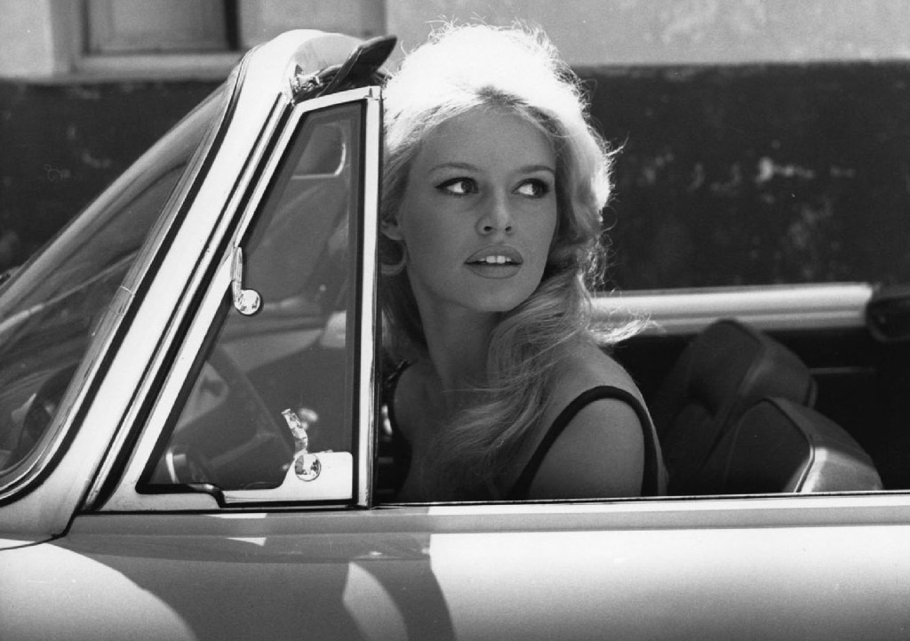 Sexy movie star Brigitte Bardot driving a cabriolet car