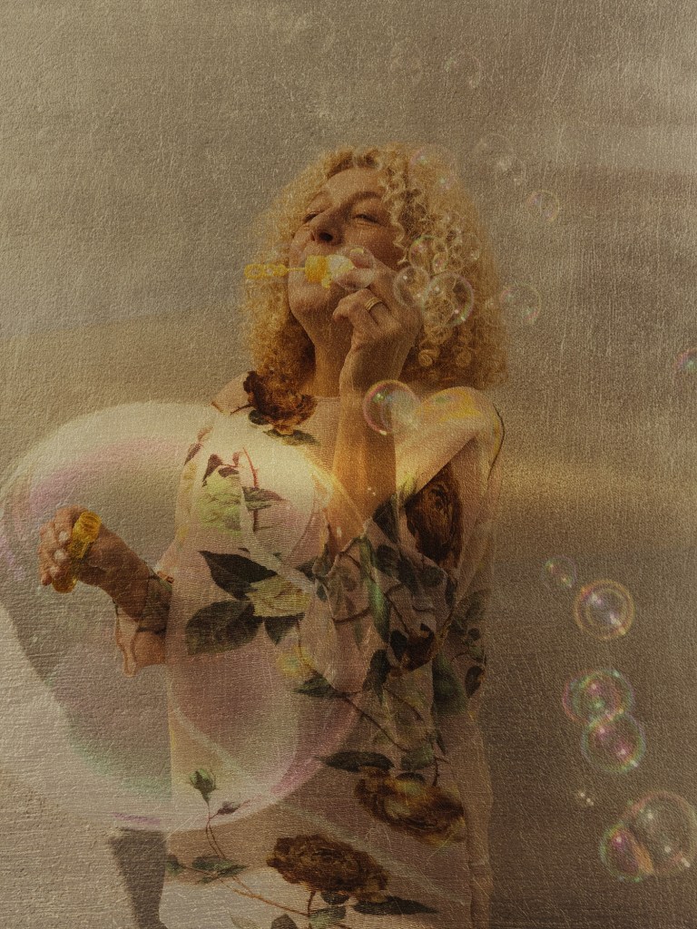 thomas de monaco luisant haze woman blowing soap bubbles