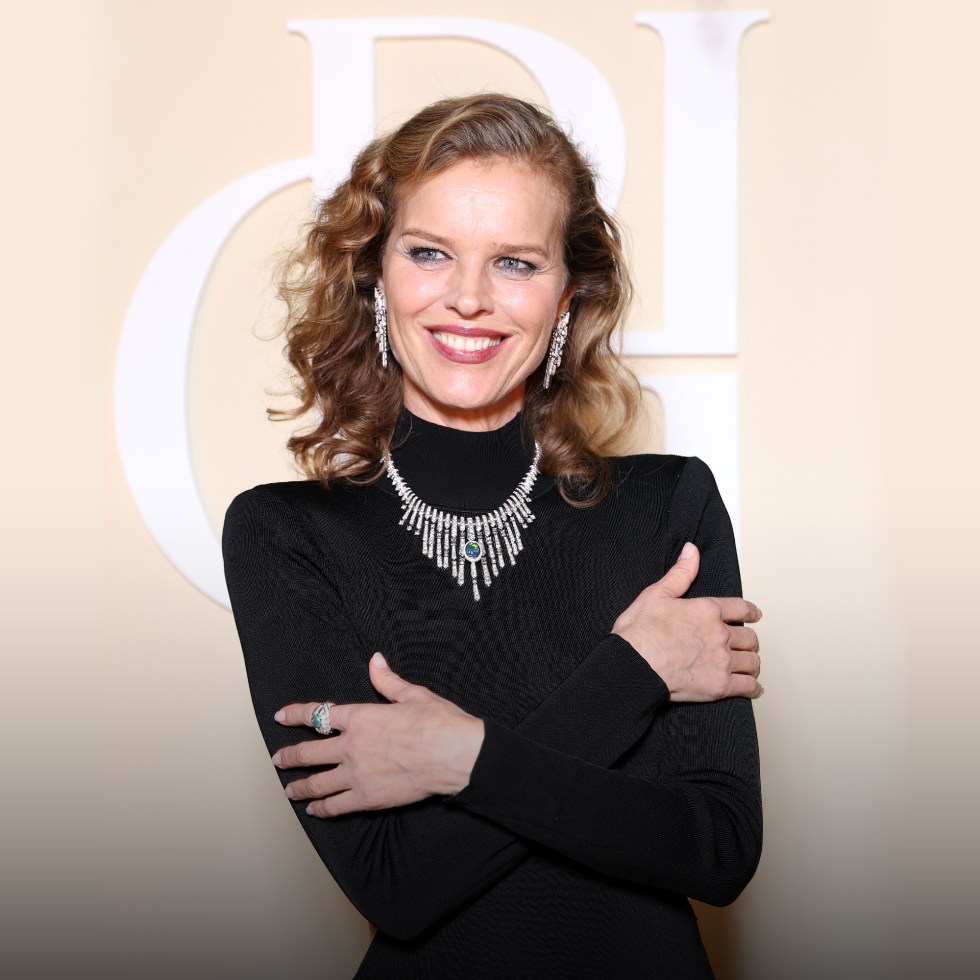 Top Model Eva Herzigova wearing diamond necklace posing with big smile