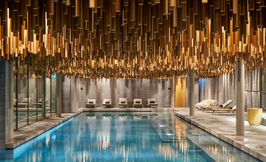 Luxurious indoor pool with artistic ceiling.