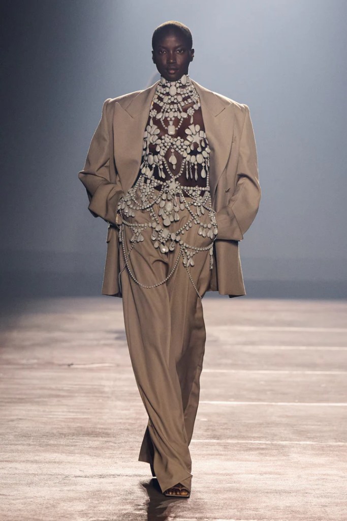 Mugler beige suit showcased by black fashion model on the runway in Paris