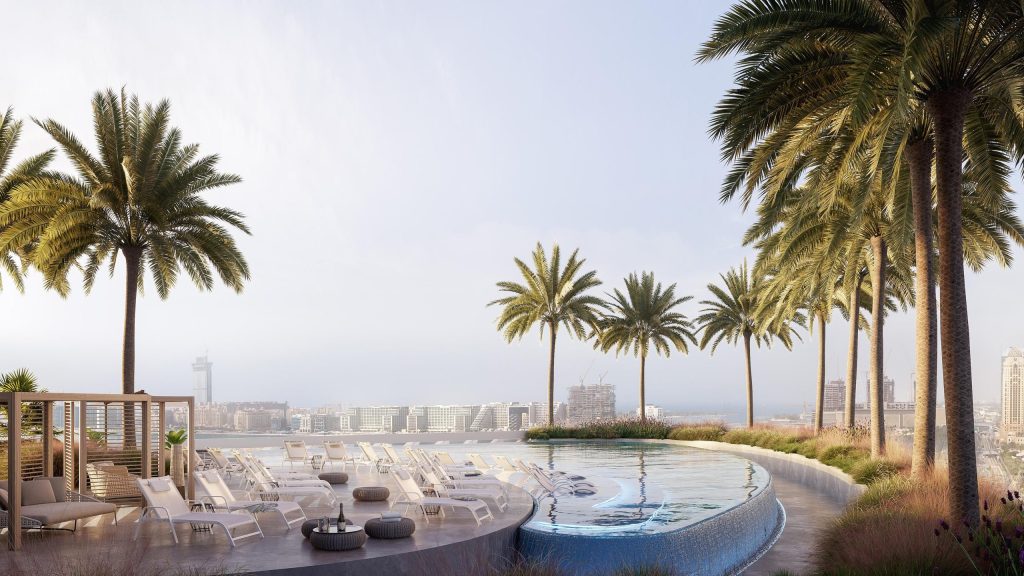 resort style swimming pool area with palm trees and Dubai skyline in the background