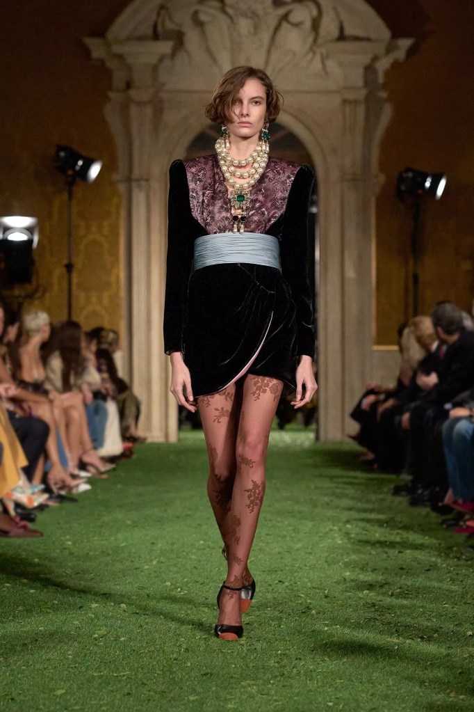 Valentino Fashion Show Fall 2026 model wears short velvet burgundy dress