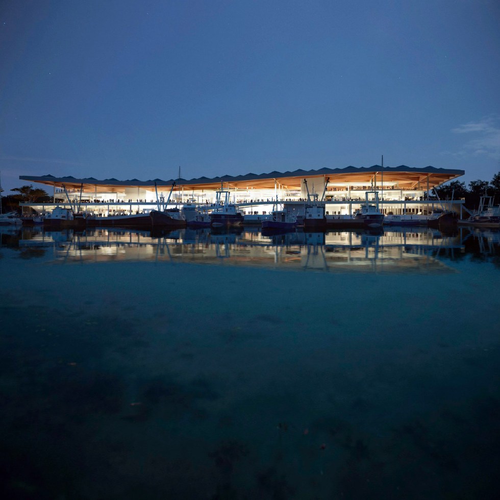 Sydney Fish Market building by the water at night