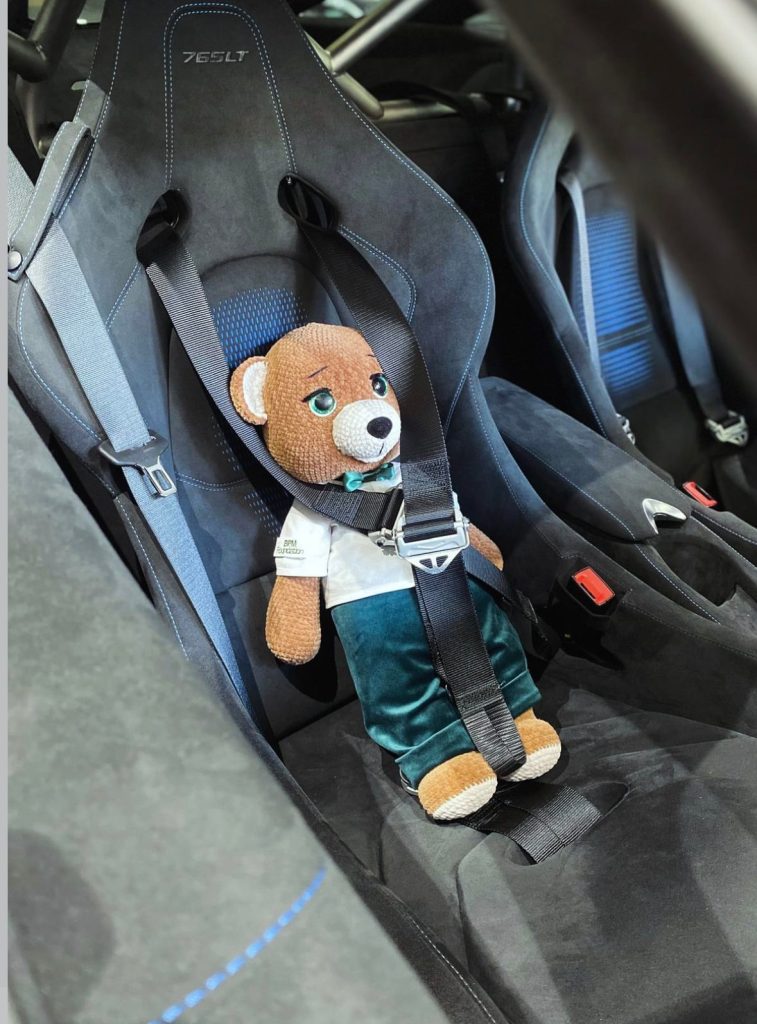 bpm foundation charity teddy bear seated inside the supercar