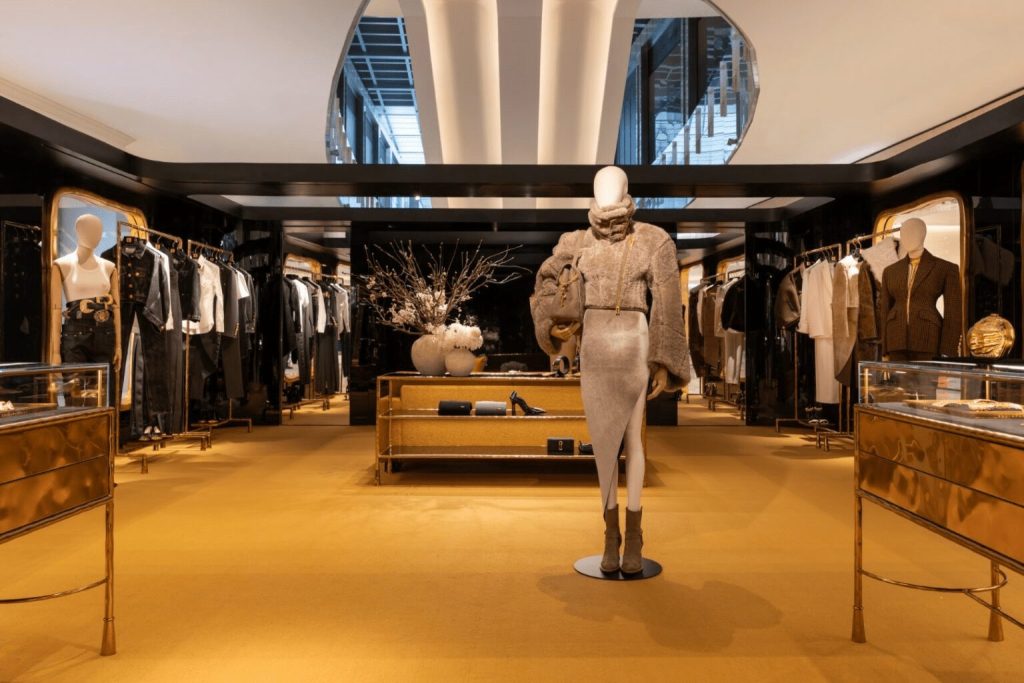 Inside the Schiaparelli shop interior with yellow floor and black walls, mannequin in the front entrance