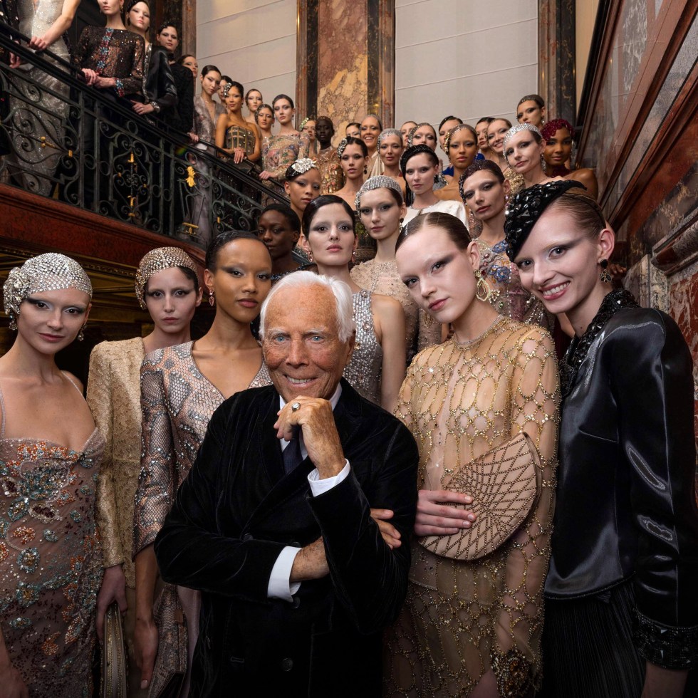 Giorgio Armani surrounded by high end fashion models wearing his haute couture collection Armani Prive