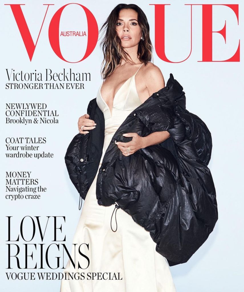 victoria beckham in a long white dress and large pugger duck down black jacket