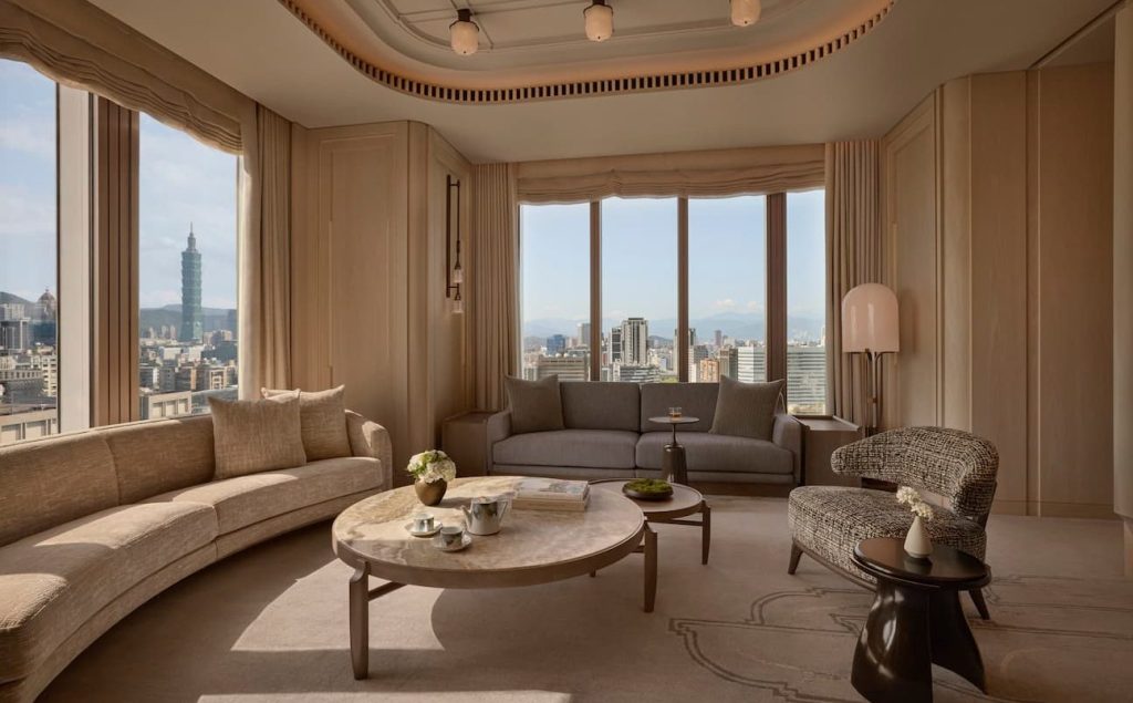 capella taipei cream furniture and large windows with the view on the city landscape