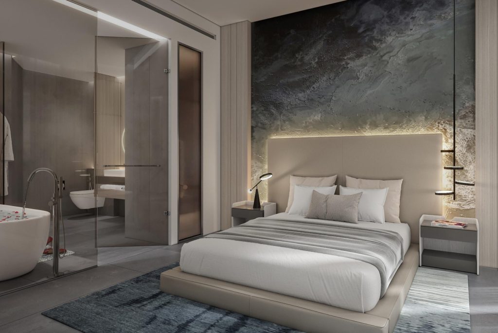 Chic hotel bedroom in calm pastel colours featuring bathtub
