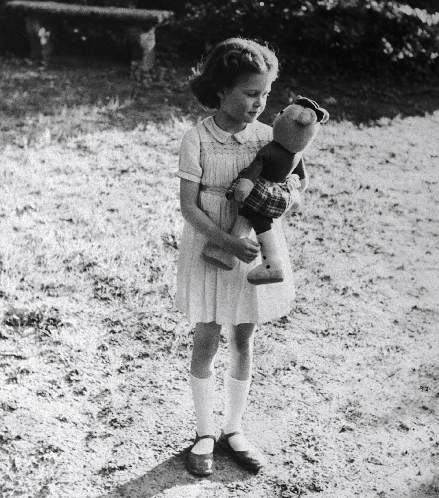 Brigitte Bardot as a child holding a teddy bear