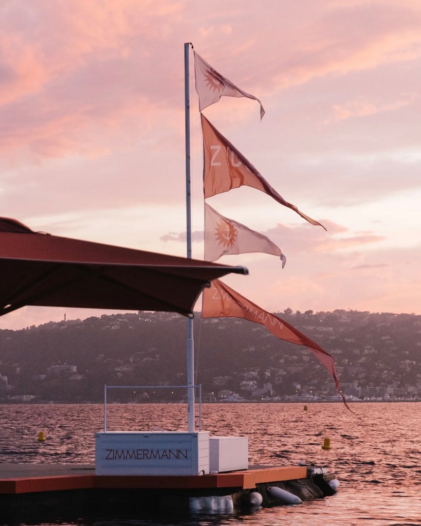 tender landing and flags branded in Zimmermann at sunset