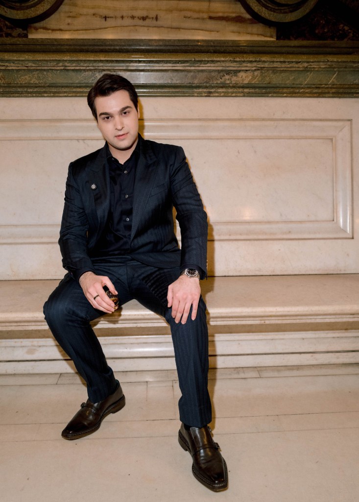 armen pogossian sitting on a marble bench at the opera garnier